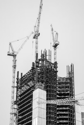 Tall building under construction with tower cranes